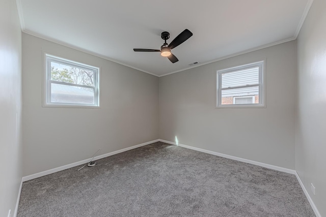 empty room featuring light carpet, crown molding, and ceiling fan