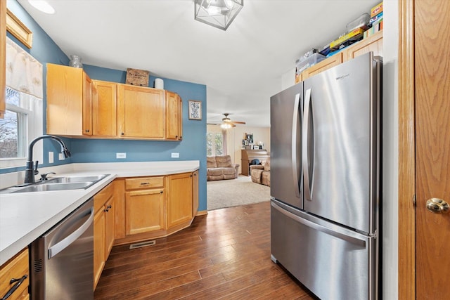 kitchen with dark wood-type flooring, sink, light brown cabinets, ceiling fan, and stainless steel appliances