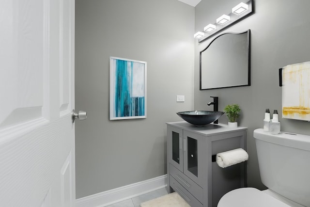 bathroom with tile patterned floors, vanity, and toilet