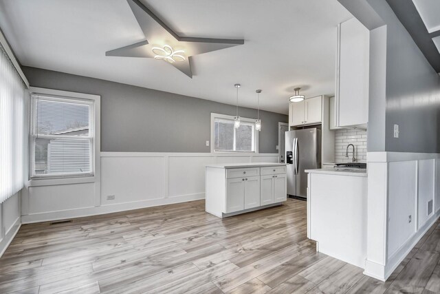 16542 Paulina St, Markham, IL 60428 - kitchen featuring light countertops, white cabinets, stainless steel fridge, and light wood finished floors