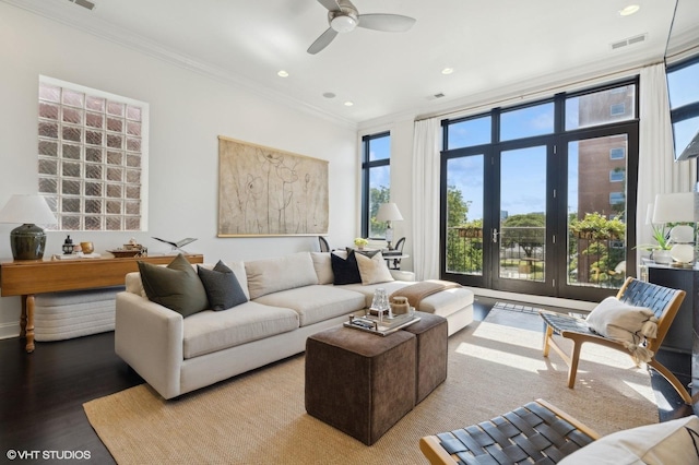 living room featuring ceiling fan, crown molding, and light hardwood / wood-style flooring