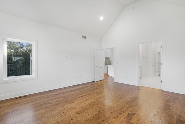 interior space with high vaulted ceiling and hardwood / wood-style flooring