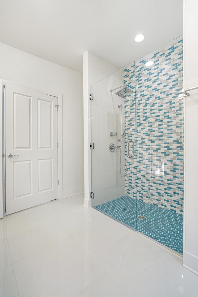 bathroom with tile patterned floors and walk in shower