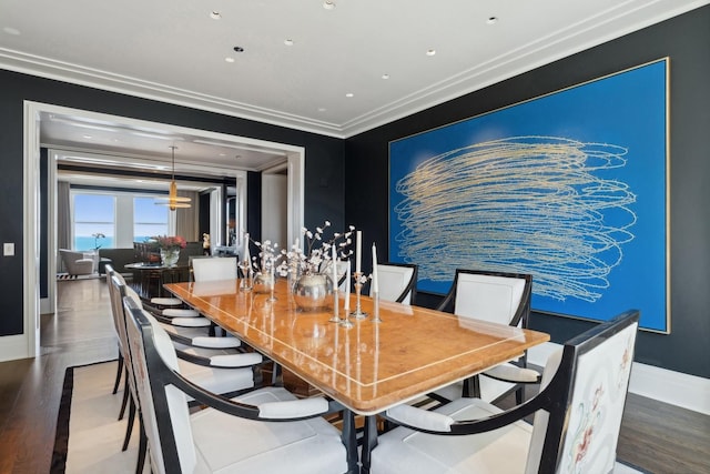 dining room featuring hardwood / wood-style flooring and ornamental molding