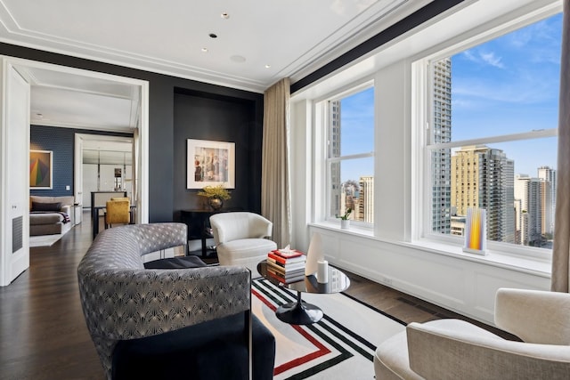 living area featuring dark hardwood / wood-style floors and ornamental molding