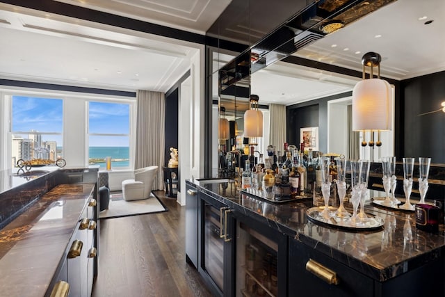 bar featuring pendant lighting, a water view, sink, ornamental molding, and dark hardwood / wood-style flooring