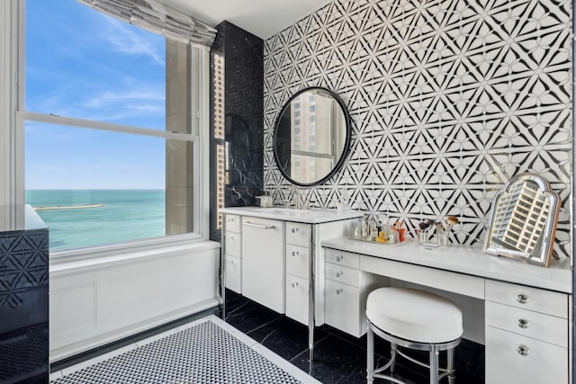 bathroom featuring vanity, a water view, and tile walls