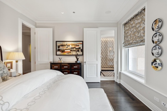 bedroom with dark hardwood / wood-style floors and crown molding