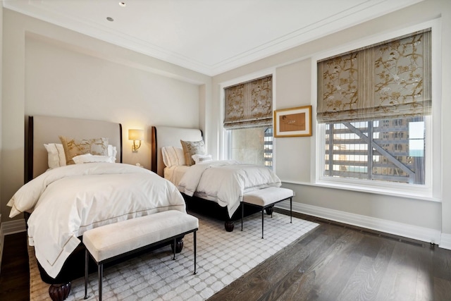 bedroom featuring crown molding and dark hardwood / wood-style flooring