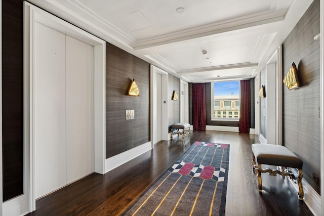 corridor featuring dark hardwood / wood-style floors, crown molding, and a tray ceiling