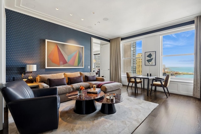 living room with a water view, dark hardwood / wood-style floors, and ornamental molding