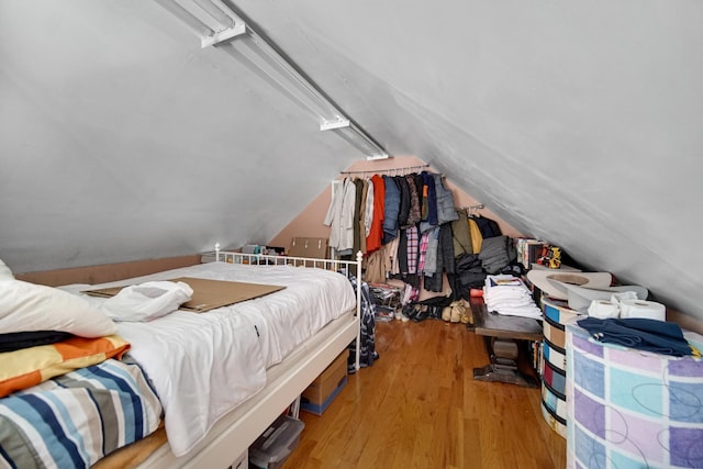 bedroom with light hardwood / wood-style floors and vaulted ceiling