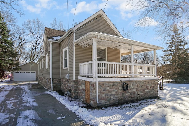 view of front facade with a porch, a garage, and an outdoor structure