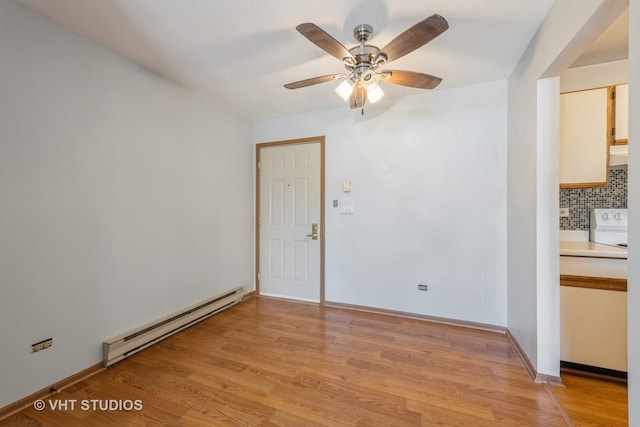 unfurnished room with baseboard heating, ceiling fan, and light hardwood / wood-style floors