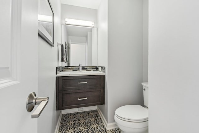 bathroom featuring tile patterned flooring, vanity, and toilet