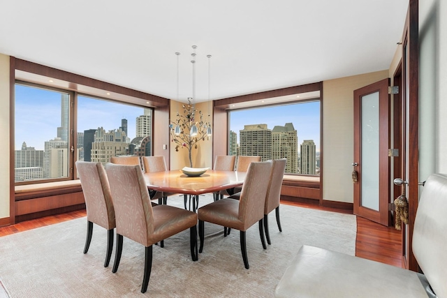 dining room featuring a notable chandelier and light wood-type flooring