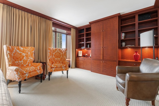 sitting room with light colored carpet and built in features