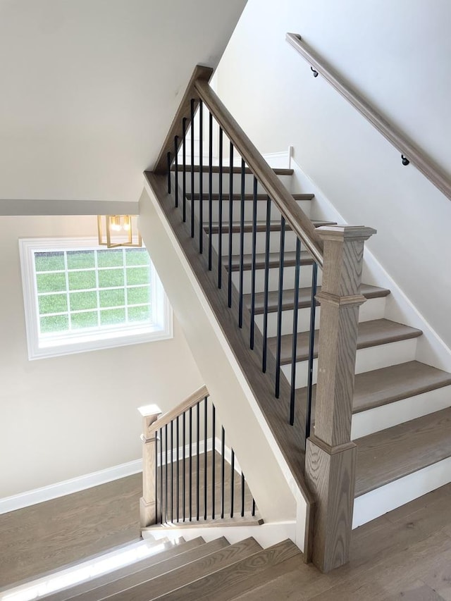 stairs featuring wood-type flooring