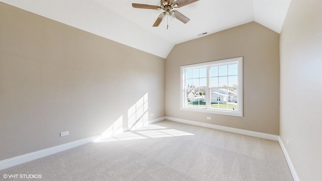 carpeted empty room featuring vaulted ceiling and ceiling fan