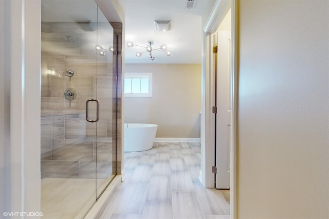 bathroom featuring wood-type flooring and separate shower and tub