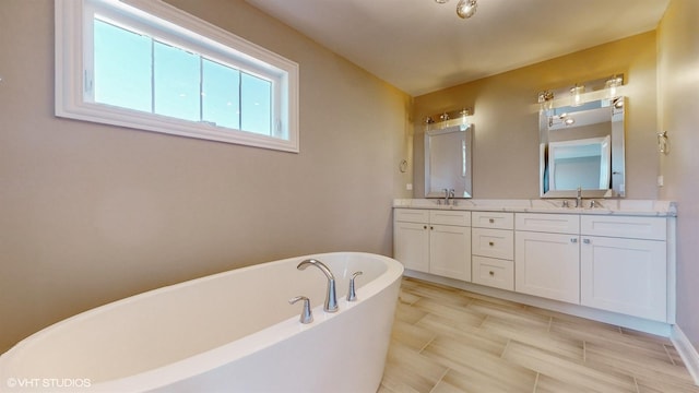 bathroom with vanity and a bathtub