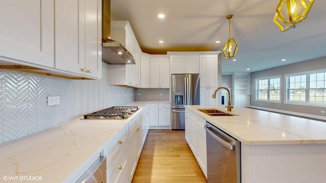 kitchen featuring white cabinets, stainless steel appliances, hanging light fixtures, and sink