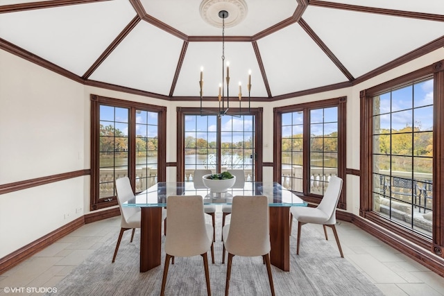 dining space featuring a wealth of natural light, vaulted ceiling, and a notable chandelier