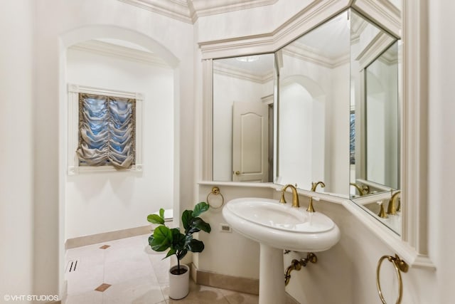 bathroom with tile patterned flooring, sink, and crown molding