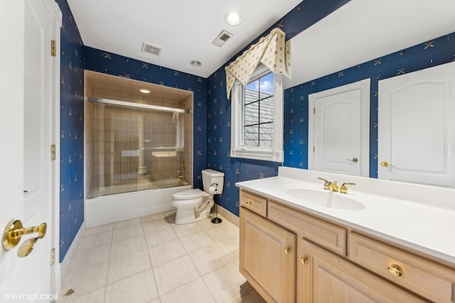 full bathroom with shower / bath combination with glass door, vanity, toilet, and tile patterned flooring