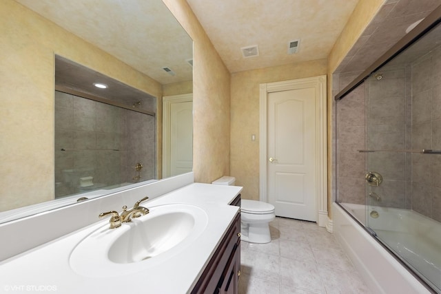 full bathroom featuring tile patterned floors, toilet, vanity, and combined bath / shower with glass door