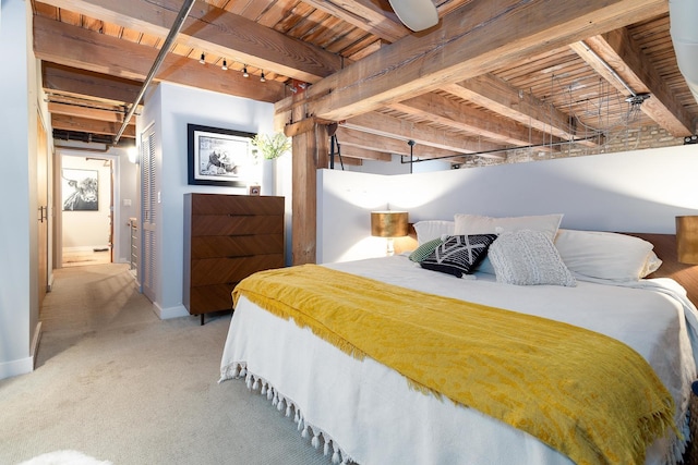 carpeted bedroom with beam ceiling