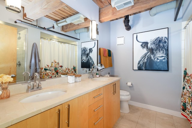 bathroom with tile patterned floors, vanity, toilet, and curtained shower