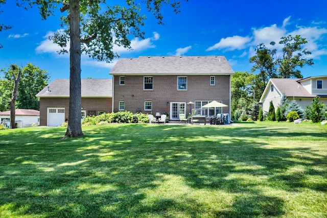 back of property featuring a lawn and a patio