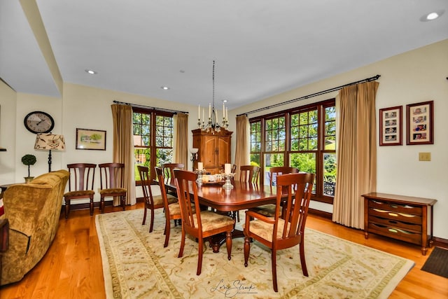 dining room with plenty of natural light, a chandelier, and light hardwood / wood-style flooring