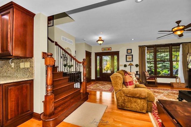 living room featuring light wood-type flooring and ceiling fan