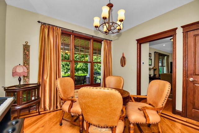 dining area featuring a notable chandelier and light hardwood / wood-style floors