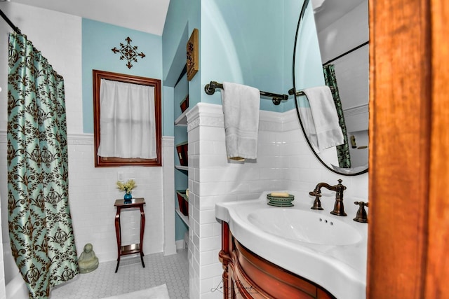 bathroom featuring tile patterned floors, vanity, and tile walls