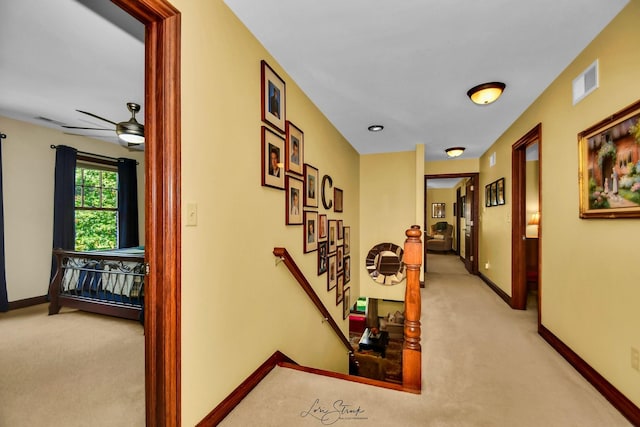 hallway featuring light carpet