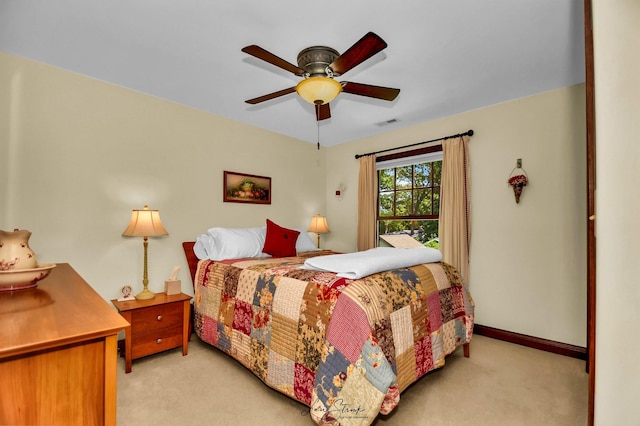 bedroom with ceiling fan and light carpet