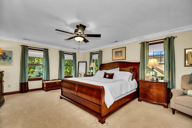 carpeted bedroom with ceiling fan and ornamental molding