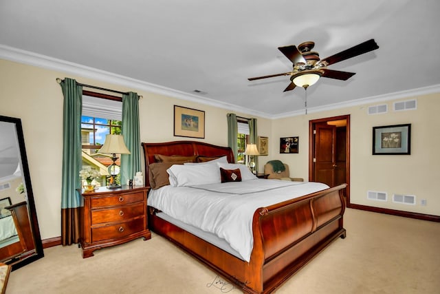 carpeted bedroom featuring ceiling fan and crown molding