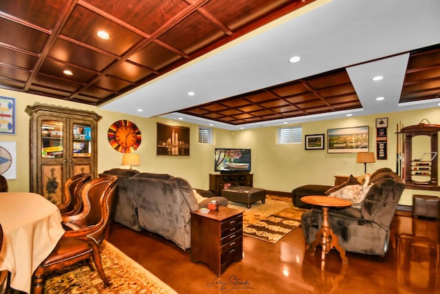 living room featuring concrete flooring and coffered ceiling