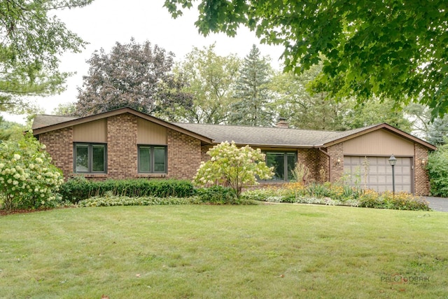 single story home with a garage and a front lawn