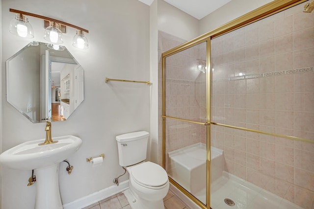 bathroom with tile patterned floors, walk in shower, and toilet