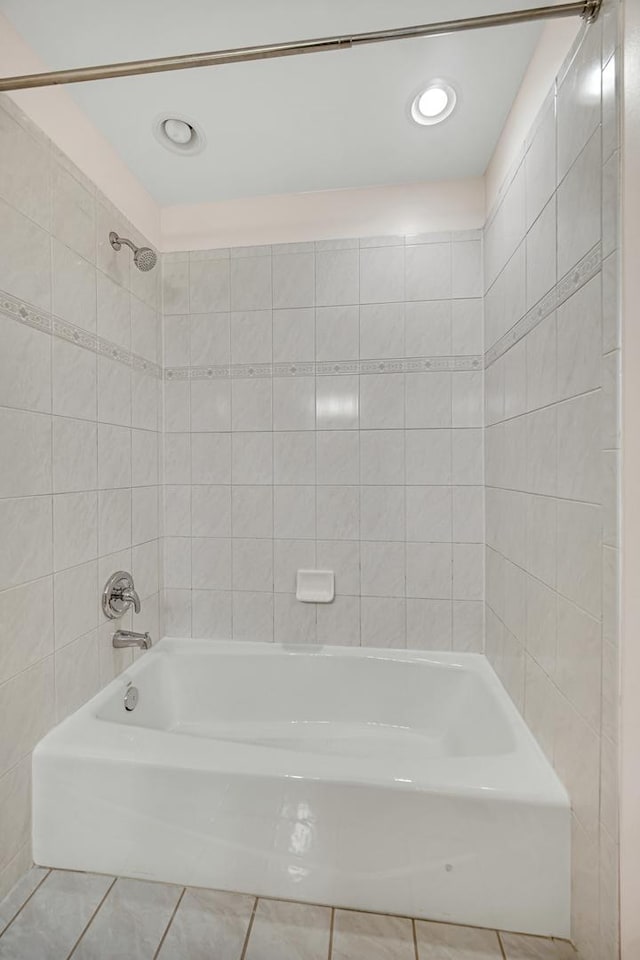 bathroom with tile patterned floors and tiled shower / bath