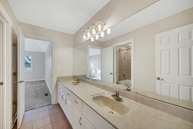 full bathroom featuring tile patterned flooring, vanity, toilet, and tiled shower / bath