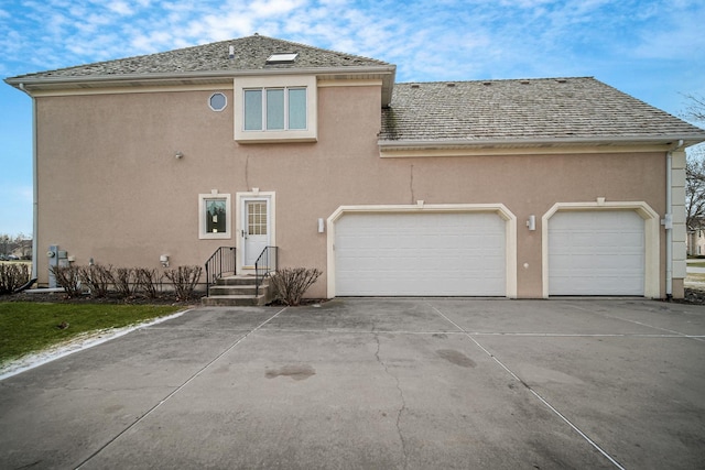 rear view of house featuring a garage