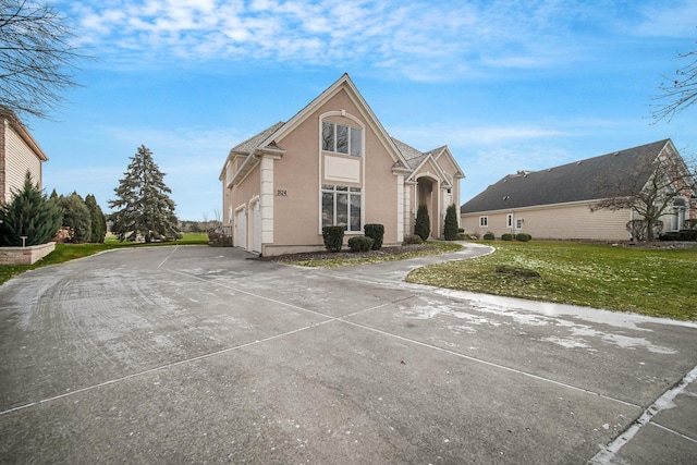 view of front property with a garage and a front lawn