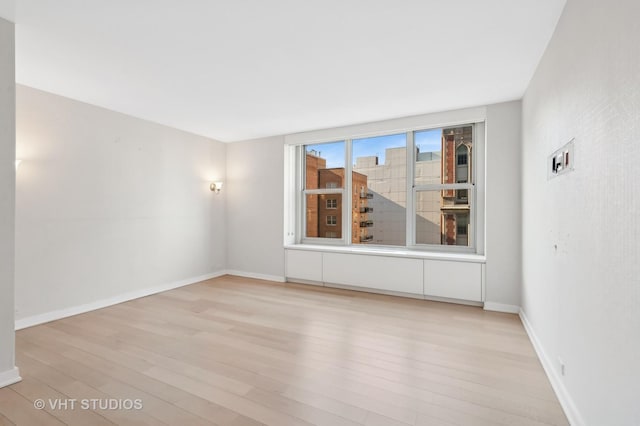 spare room featuring light hardwood / wood-style floors