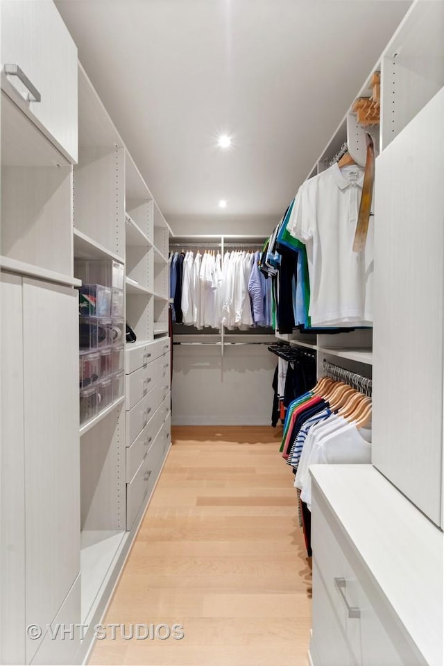 walk in closet featuring light hardwood / wood-style flooring